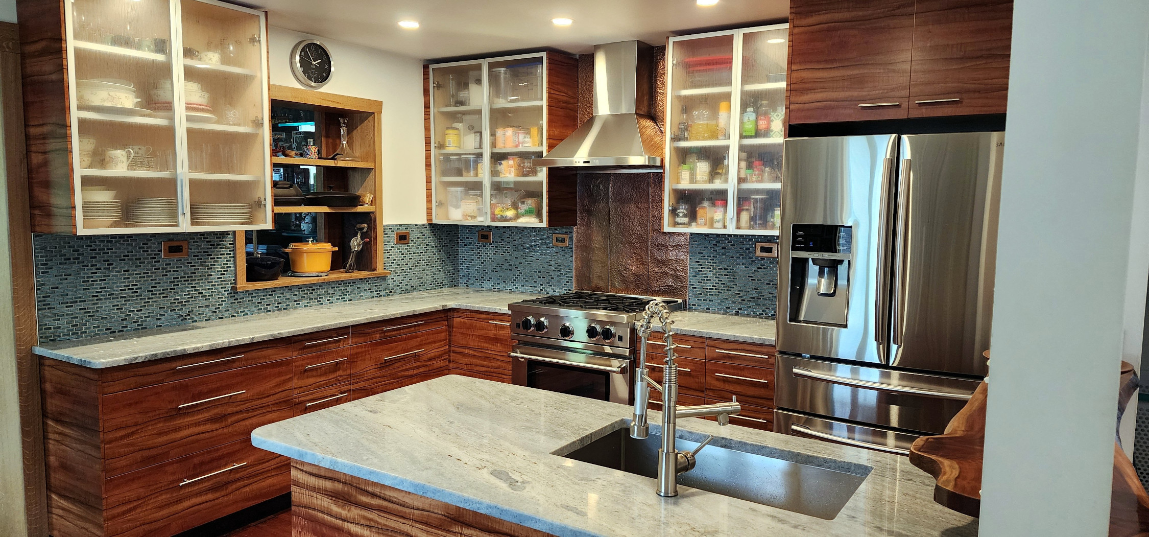 Full kitchen view with glass-front cabinets and open shelving